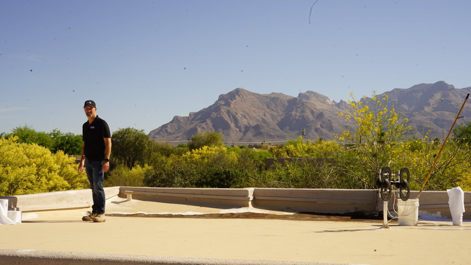 DSR Roofing owner inspecting a freshly coated flat roof in Tucson