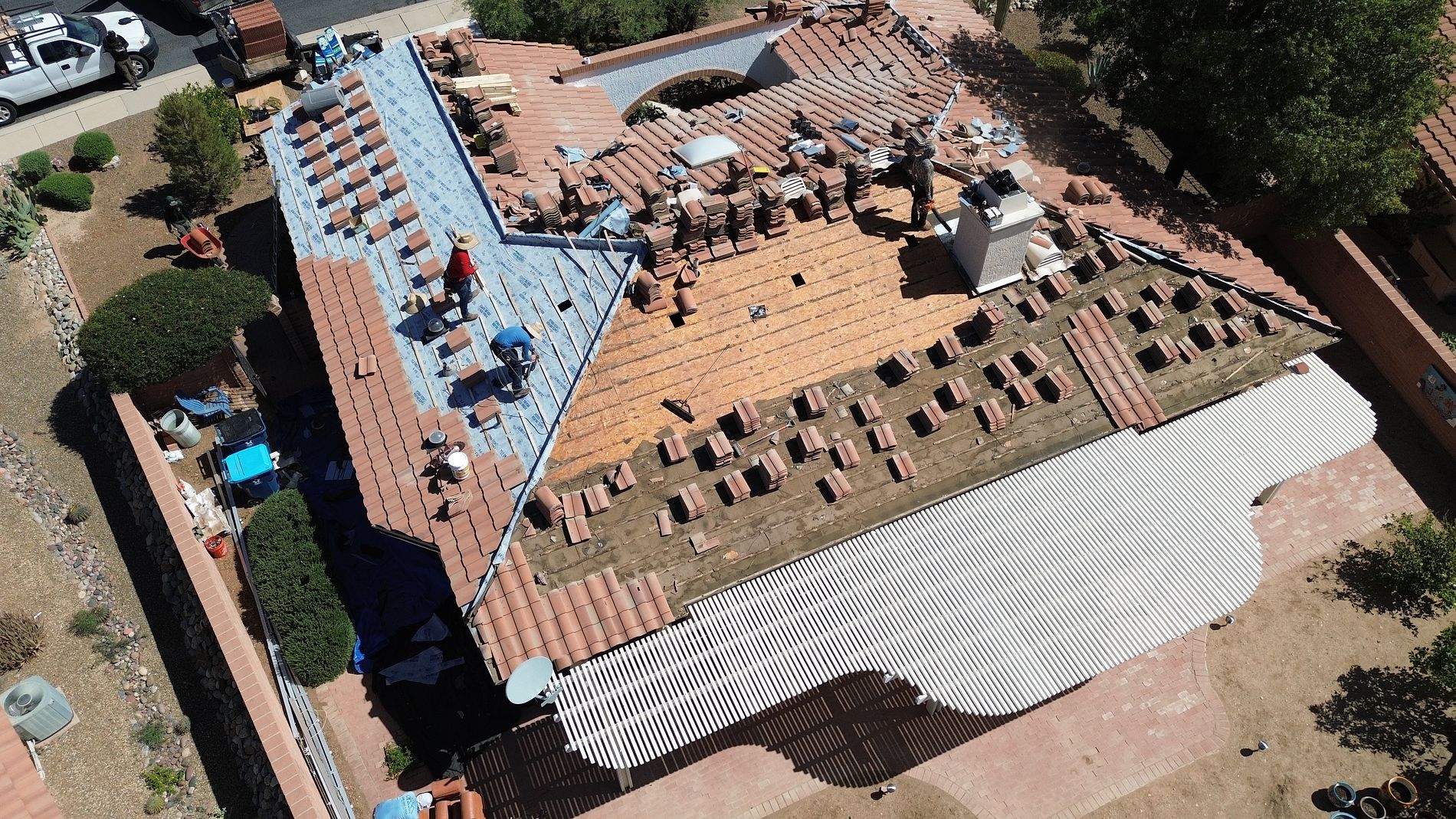 DSR Roofing crew replacing a tile roof in Tucson, aerial view